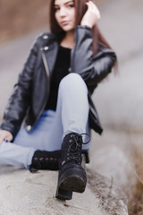 Fototapeta na wymiar Young woman wearing trendy black lace-up boots