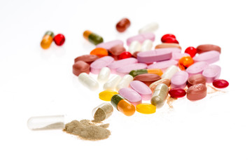 Colored pile of pills on white backgound