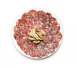 Traditional Iberian Salami Sausage dish (Salchichon Iberico) with breadsticks isolated on white background. Iberian salchichon. Iberian pork meat. Top view.