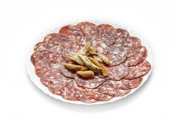 Traditional Iberian Salami Sausage dish (Salchichon Iberico) with breadsticks isolated on white background. Iberian salchichon. Iberian pork meat.