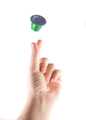 green coffee capsule on white background