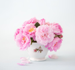 Bouquet of  pink roses on light grey background.