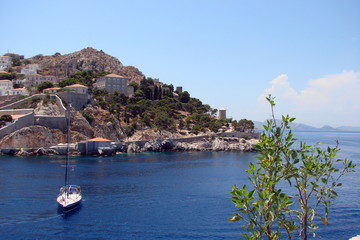 View of the seaside Greek town in the southern Greek Islands on the background of the blue sky.