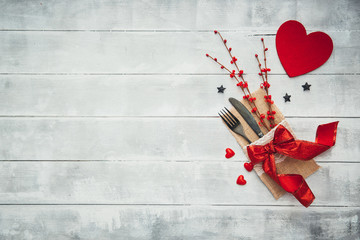 Fork, knife, napkin, heart. Celebrate valentine's day. Serving, Table decoration Valentine's Day, table set with a decorative heart. Image of dinner on Valentines day. Top view, copy space.