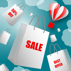 White paper bags with sales labels flying out of flying balloon in shape of heart against blue sky with clouds. Sale, Best Offer, Shopping, Fashion, Business, Valentine's Day