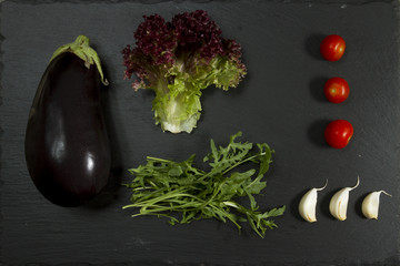 SUMMER FRESH VEGETABLE MIX. ABSTRACT OVERHEAD STILL LIFE WITH EGGPALNT AND SALAD INGREDIENTS