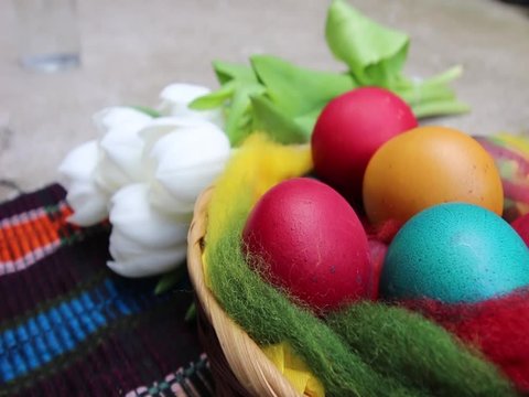     Close up of colorful painted easter eggs in a basket - hd video 
