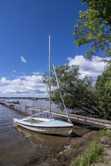 Boat by a dock at a cottage in Muskoka, Ontario, Canada