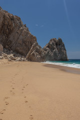 Fototapeta na wymiar Footsteps in the sand at Lovers Beach in Cabo San Lucas, Mexico