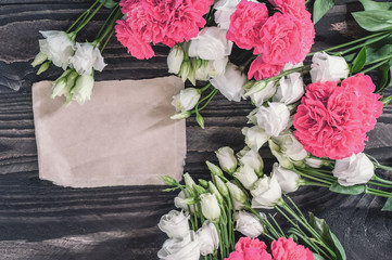 Beautiful background of red and pink roses and white eustoma flowers on wooden background. For Mother's Day and Valentine's day . Copy space.