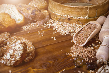 Assortment of baked bread on wooden table background