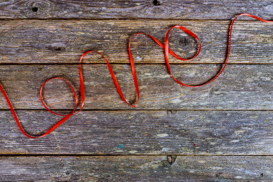 Inscription love from red wool thread on a old wooden