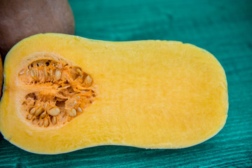 Fresh pumpkin cut in half with seeds in it