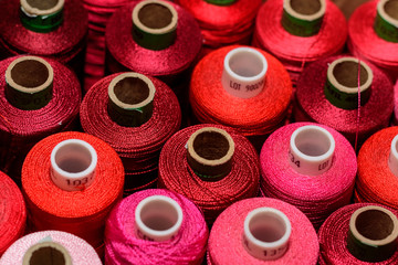 Spools of red threads closeup