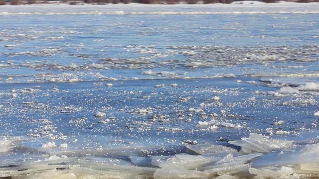 The river freezes, breaks the ice