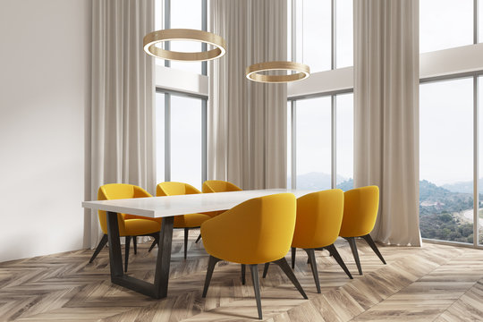 White dining room corner, yellow chairs