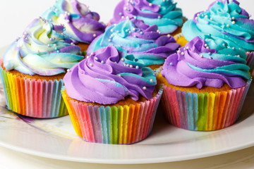 Colorful cupcakes on a plate.