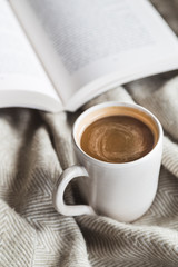 Cozy cup of hot chocolate with book
