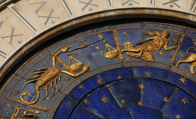 Fototapeta na wymiar Horoscope and Astrology. Detail of Saint Mark Square renaissance Clock Tower in Venice with zodiac signs Scorpio, Libra Virgo, planet and stars (15th century)