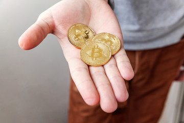 Cryptocurrency golden and silver bitcoins coin in man hand. Electronic virtual money for web...