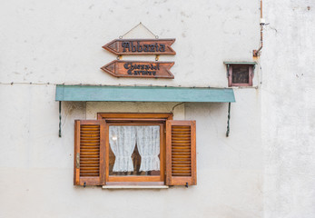 Small wooden window with two arrows pointing to the church and the abbey of Carmine. Pescasseroli,...
