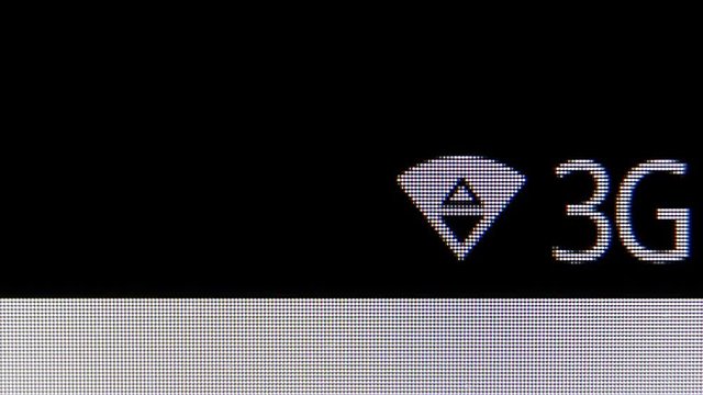 WIFI and 3G icons on the Screen of phone. MACRO VIDEO where the pixels of the screen are visible.