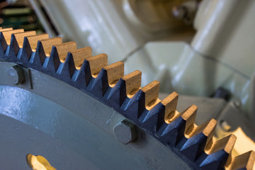 Metal big gear teeth machine close up.