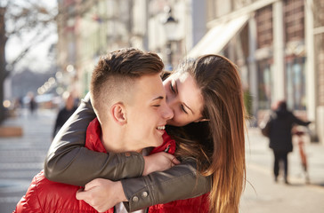 young couple, girl friend on his neck in spring