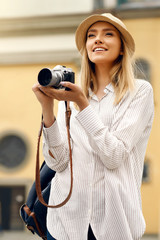 Tourist Girl With Camera Taking Photos On Street.