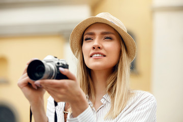 Woman Taking Photos On Camera On Street