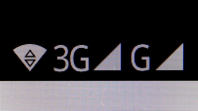 WIFI , 3G and G icons on the Screen of phone. MACRO VIDEO where the pixels of the screen are visible.