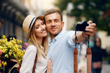 Beautiful Couple Taking Photos With Camera On Street.