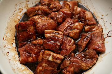 Fresh pork ribs marinated in the garnet sause narsharab. Close up.
