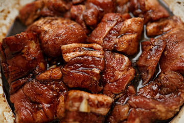 Fresh pork ribs marinated in the garnet sause narsharab. Close up.