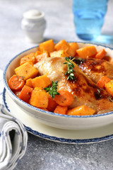 Roasted chicken legs with pumpkin and carrot.