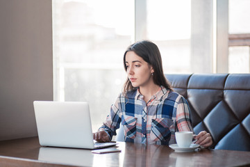 girl working with laptop in cafe