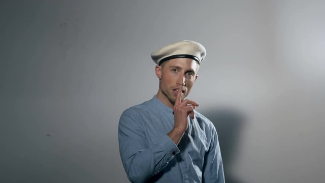 Portrait of a Male Model Wearing a Beret and Pointing Forward