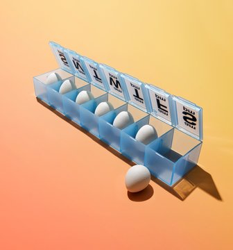 Close Up Of Eggs In Blue Pill Box