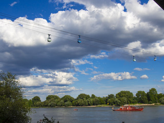 Red rescue boat on a river in Germany and the cable car