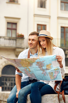 Travel. Tourist Couple With Map On Street