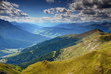 Summer sunshine over grassy Carnic main ridge, Helm peak, Val di Sesto and Pusteria valleys, Sesto Sexten, San Candido Innichen villages, Dolomites Tauern and Zillertal Alps, Alto Adige Sudtirol Italy