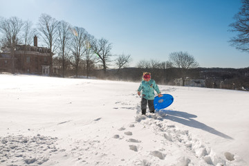 Girl Carrying Blue Sled