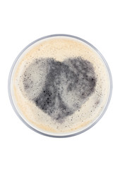Glass of stout beer top with heart shape