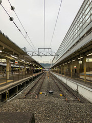 Empty train track in a cloudy day.