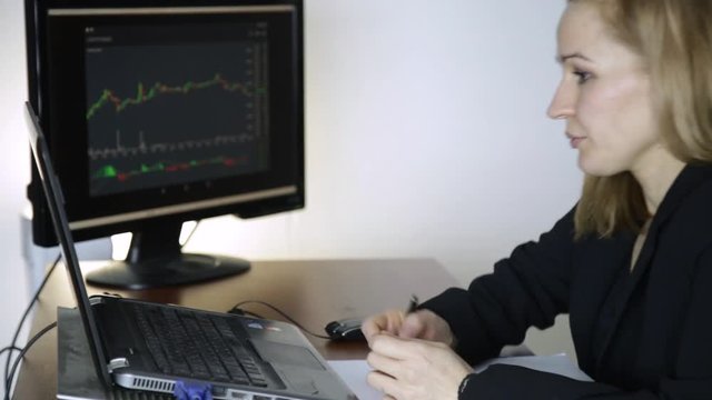 female trader working on laptop in office. Work on a crypto stock exchange. currency exchange chart at the computer monitor