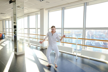 Blonde man doing aerobic movements for warming up.