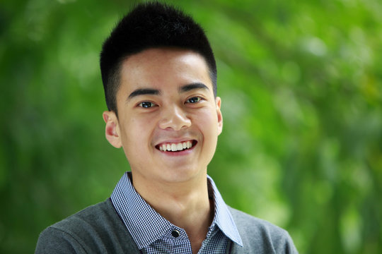 young asina man smile at camera outdoor