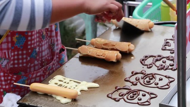 close up baking on hot plate  steet food with cartton art