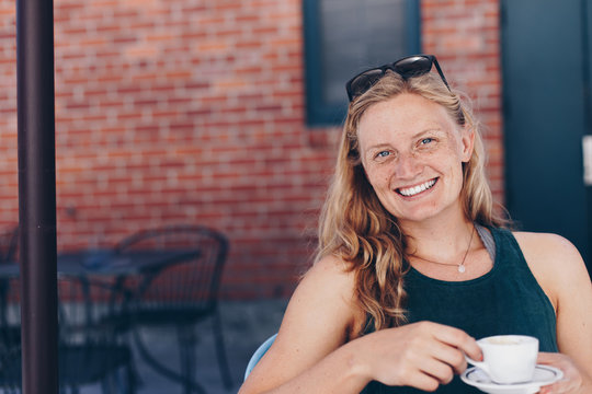 Blonde Woman with Freckles at a Coffee Shop