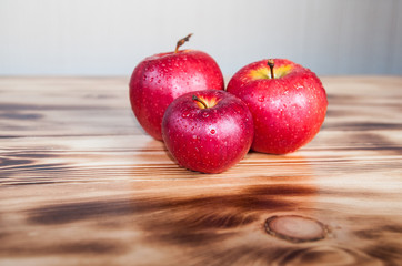 red apples on burned boards